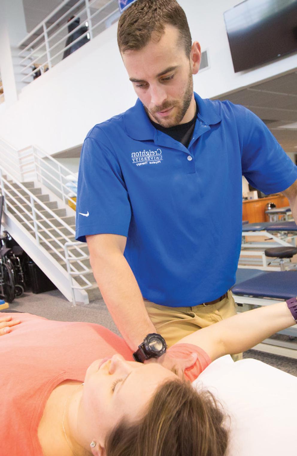 Student performing PT on womans arm