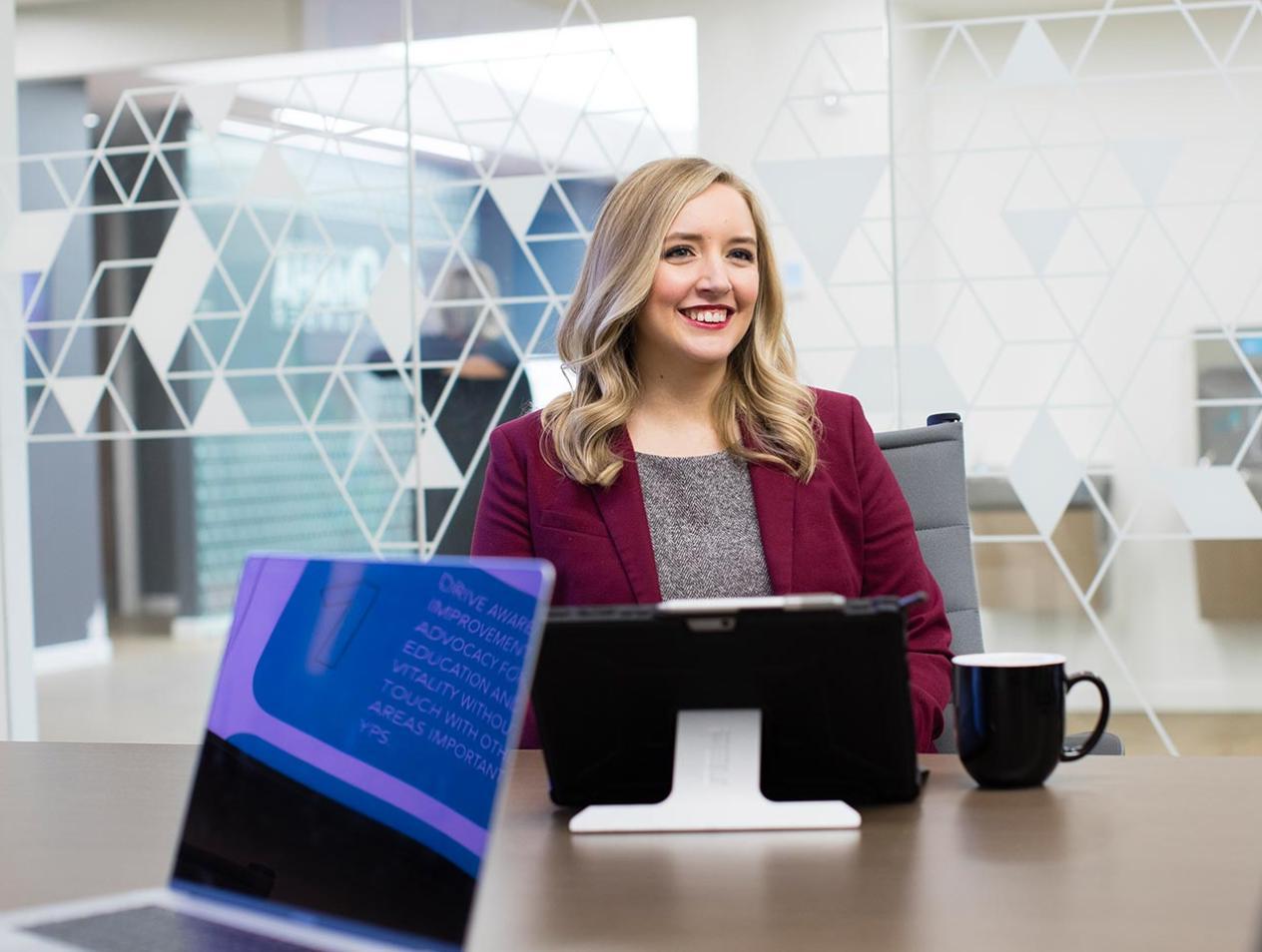 Professional woman sitting at table in conference room