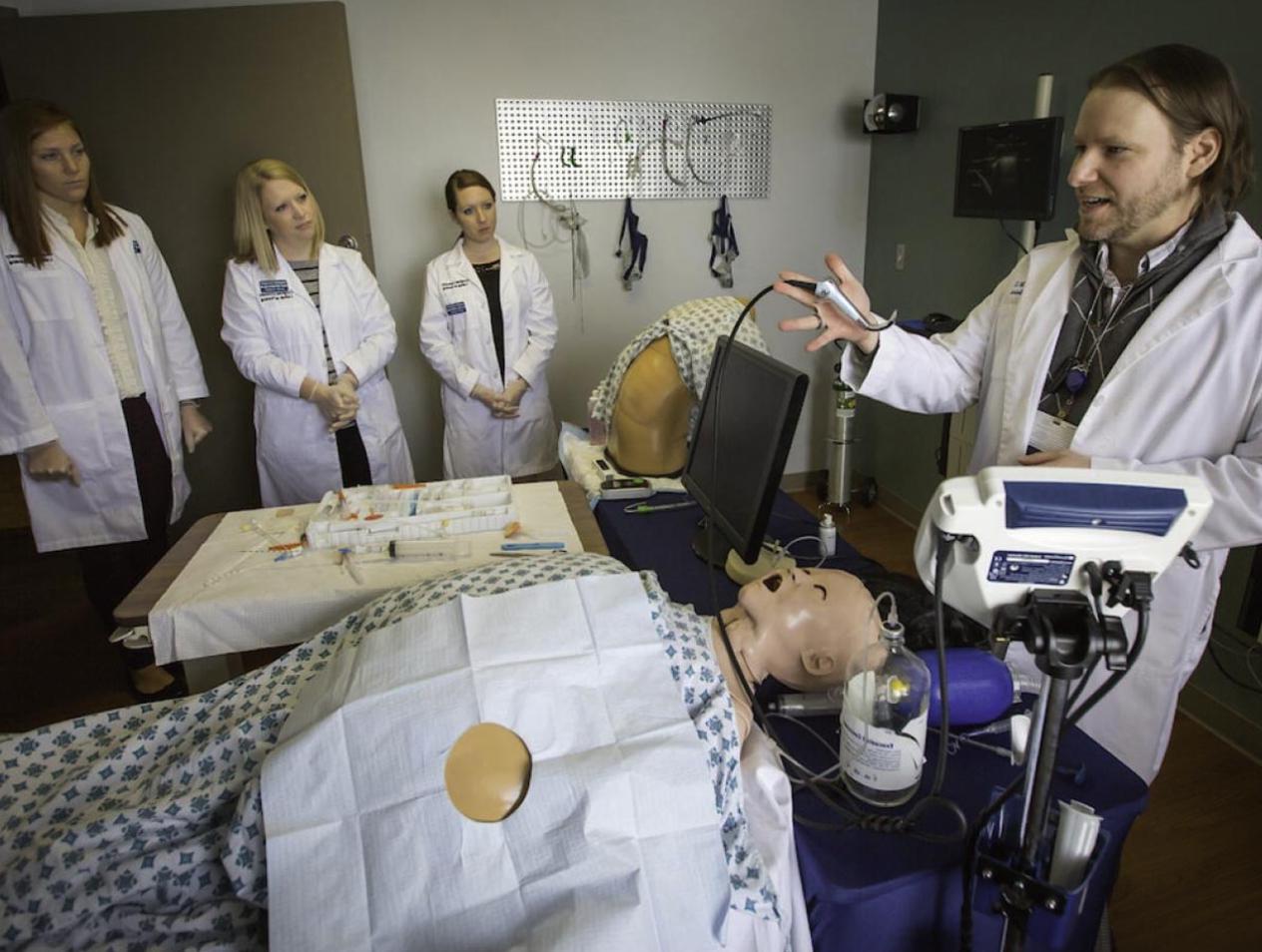 Nursing students receiving hands-on experience in simulation lab.