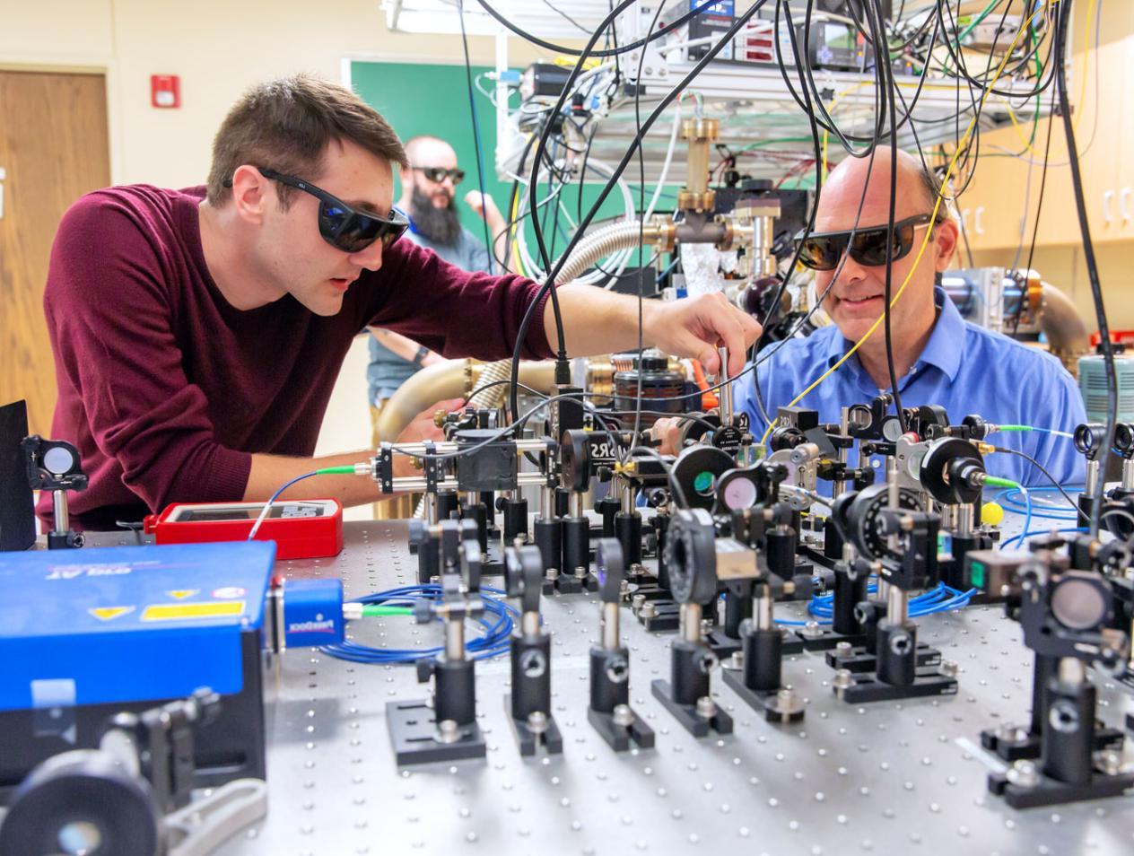 Physics faculty and student working in lab