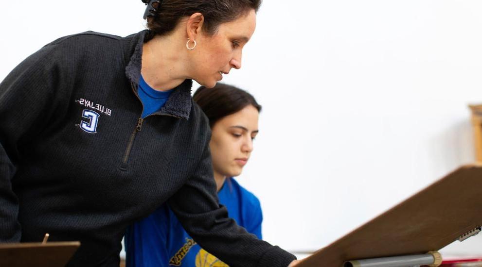 Professor pointing to student drawing