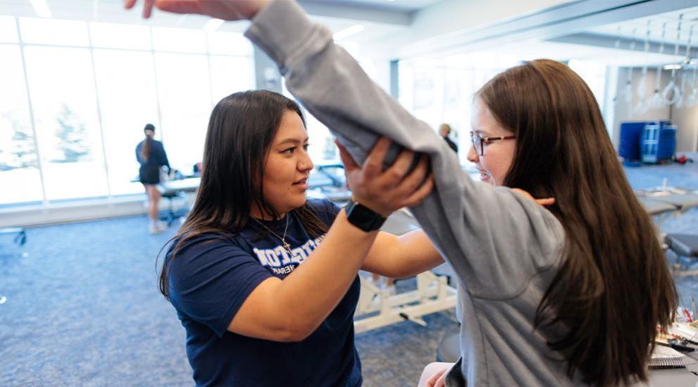 Physical therapy resident working with patient